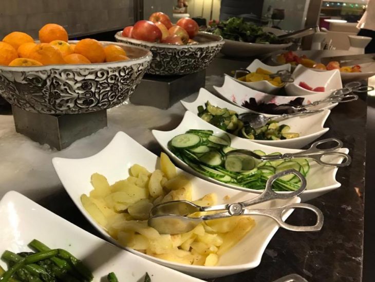 a row of bowls of fruit and vegetables