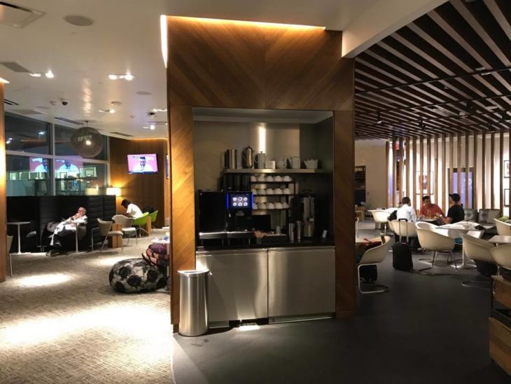 a room with a coffee bar and people sitting in chairs
