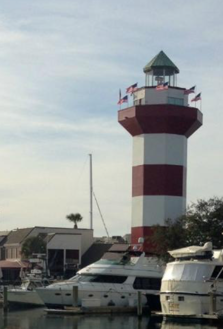 a lighthouse with flags on top