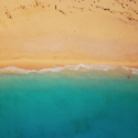 a beach with blue water and sand