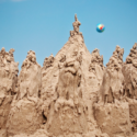 a sand castle with a ball in the air