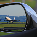 a airplane taking off from a rear view mirror