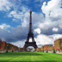 a tall metal tower with trees and grass