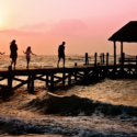 a group of people walking on a dock