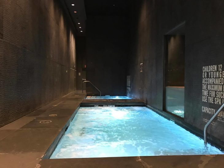 a indoor pool with a light blue light