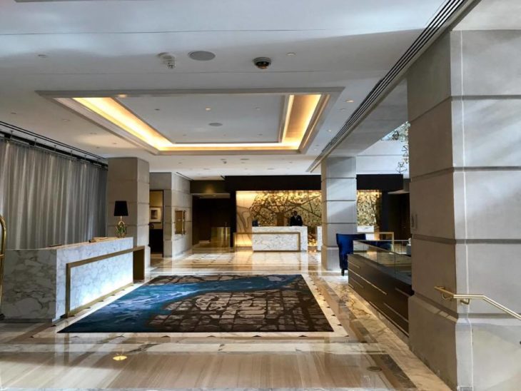 a lobby with a large carpet and a large window