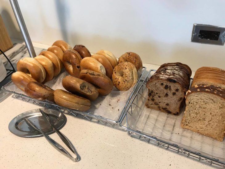 a tray of bagels and bread