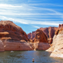 a body of water surrounded by red rock formations