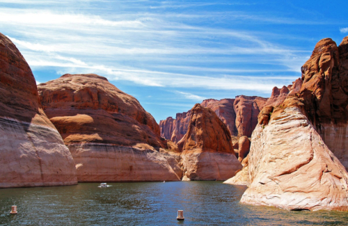 a body of water surrounded by red rock formations