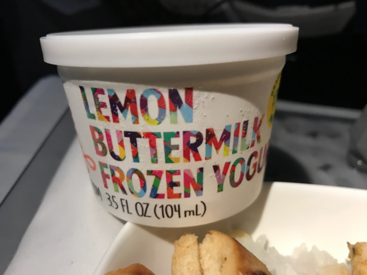 a container of yogurt and a cookie