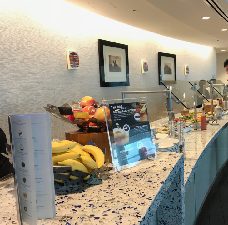 a counter with fruit and a bowl of bananas
