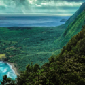 a green hills and a body of water