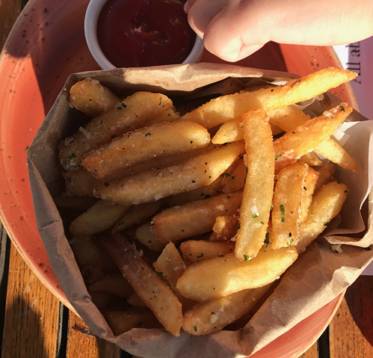 a basket of french fries on a plate