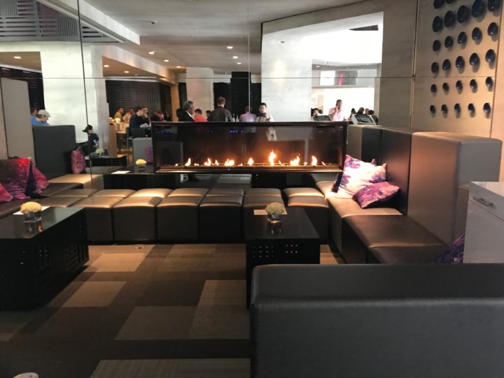 a room with a fireplace and people in the background