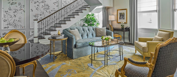 a living room with a couch and a staircase