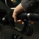 a hand holding a gas pump