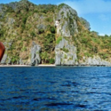 a body of water with a cliff and trees