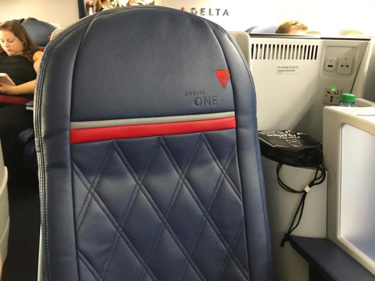 a blue and red seat on an airplane