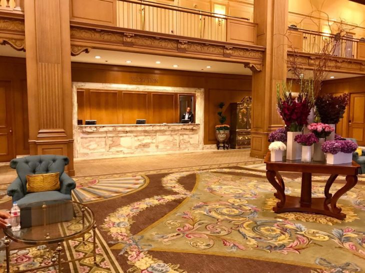 a lobby with a reception desk and a chair