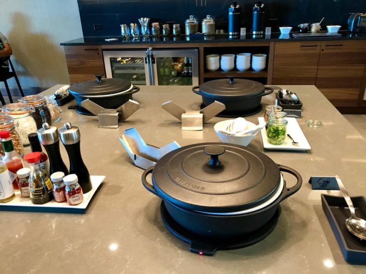 a kitchen with a table with pots and pans