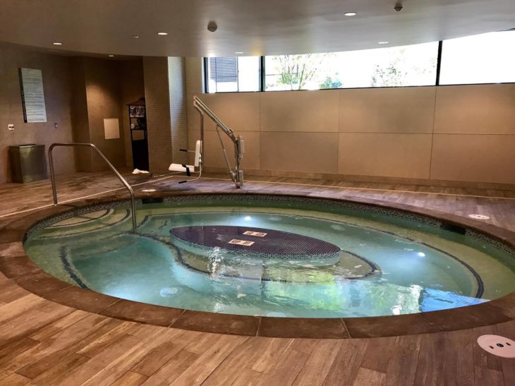 a large indoor hot tub with a round pool