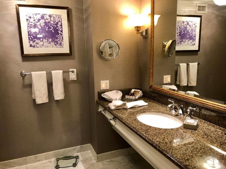 a bathroom with a marble countertop and a mirror