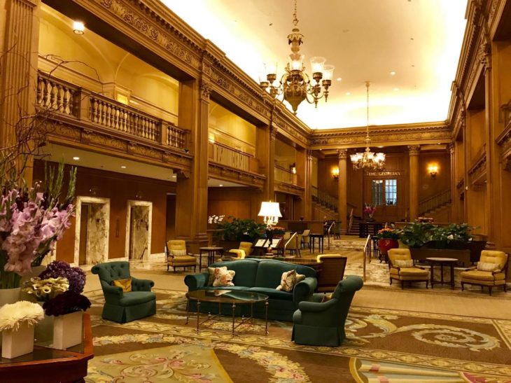 a large room with a large chandelier and chairs