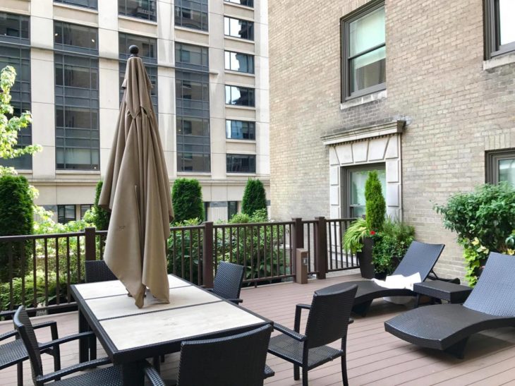 a patio with chairs and a table