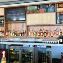 a bar with bottles of liquor and glasses