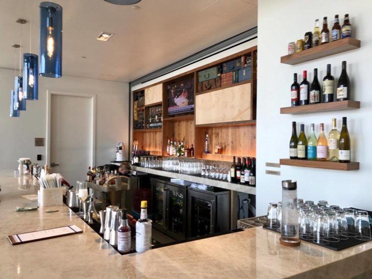 a bar with bottles and glasses on the counter