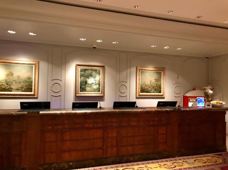 a reception desk with art on the wall