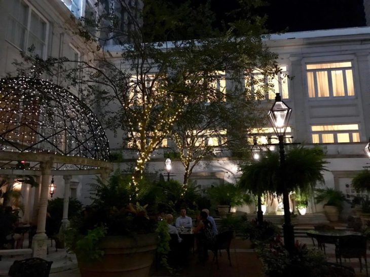 a group of people sitting at a table in front of a building