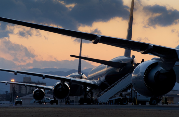 a group of airplanes parked on a runway