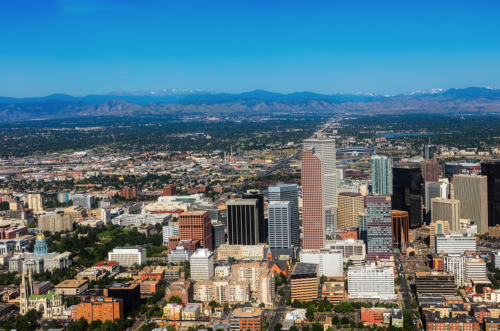 a city with many tall buildings and mountains in the background