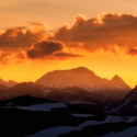 a sunset over a mountain range