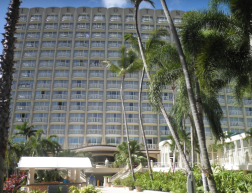a large hotel with palm trees