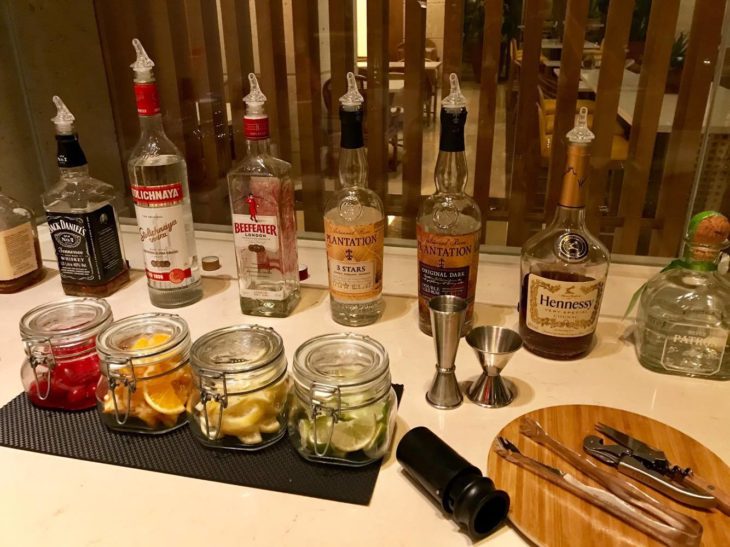 a table with bottles of alcohol and utensils