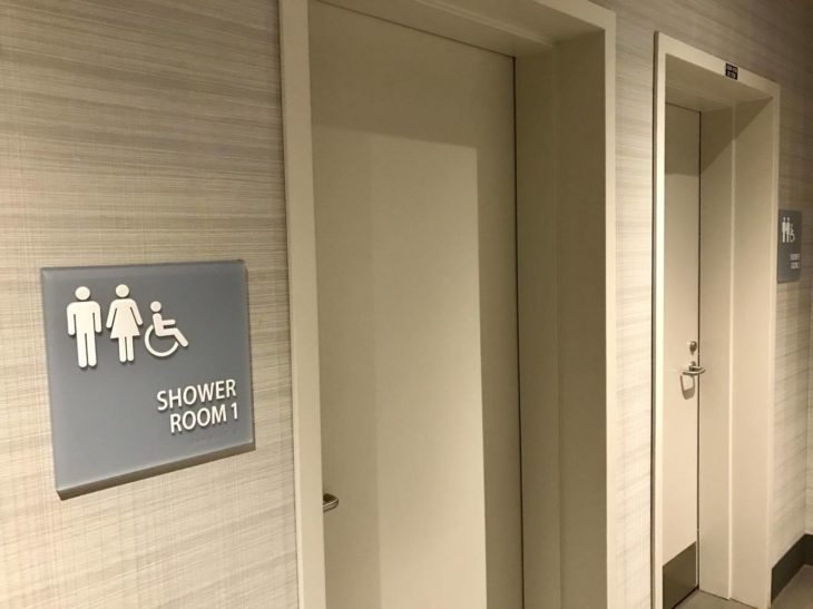 a bathroom with a sign and doors