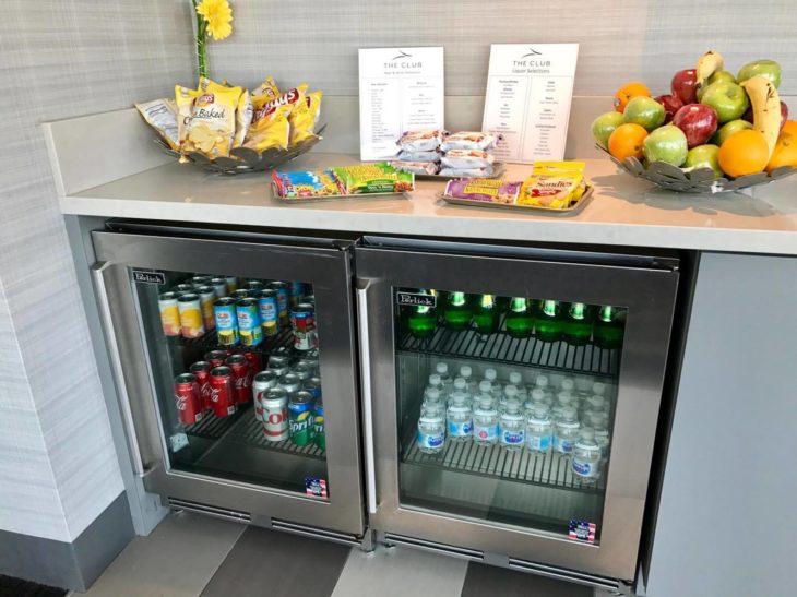 a refrigerator with drinks and snacks on a counter