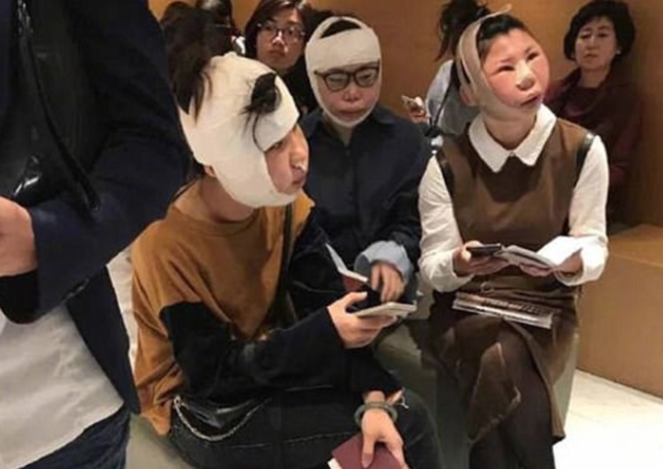 a group of people with bandages on their faces