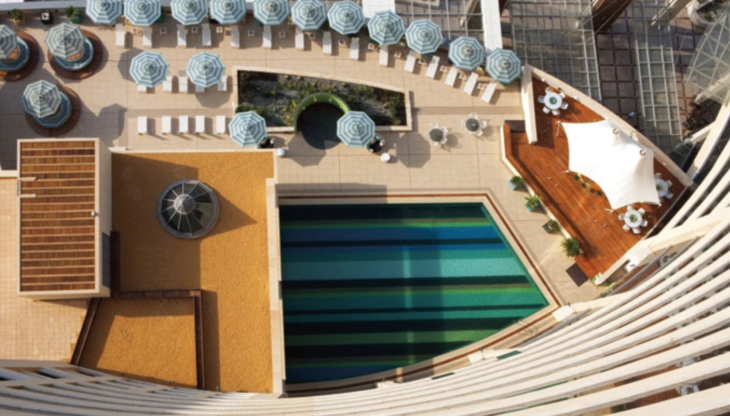 a pool and chairs on a building