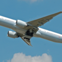 a large white airplane flying in the sky