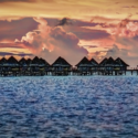 a group of huts on a pier