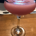 a pink drink in a glass
