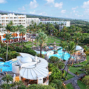 a resort with palm trees and a pool