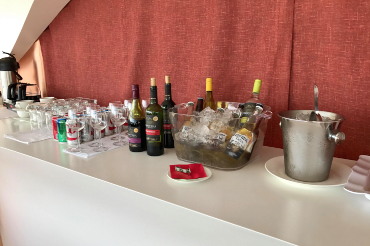 a group of bottles of alcohol and glasses on a table