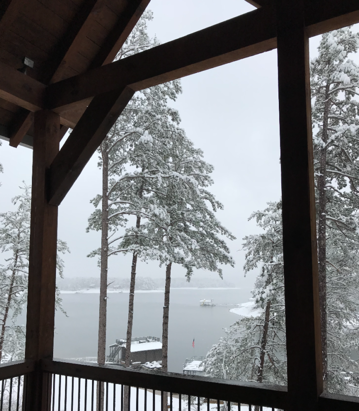 a view of a snowy lake from a porch