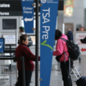 a woman standing next to a sign