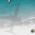 a shadow of a plane on a beach