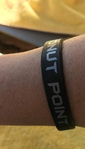 a black rubber wristband with white text on it
